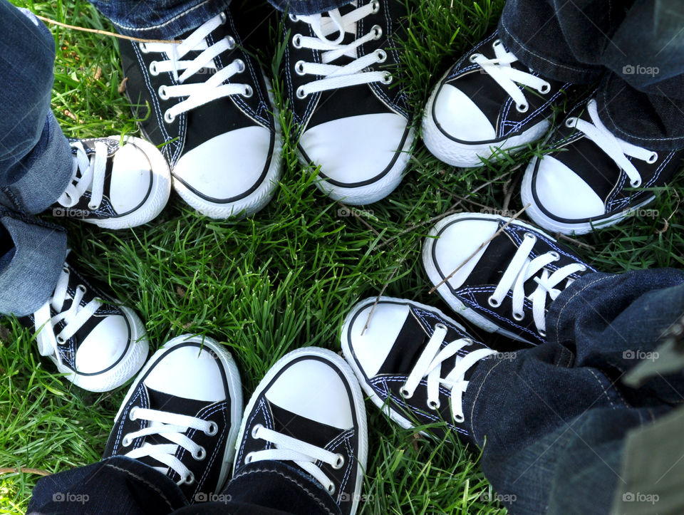 Family Circle of matching black and white tennis shoes