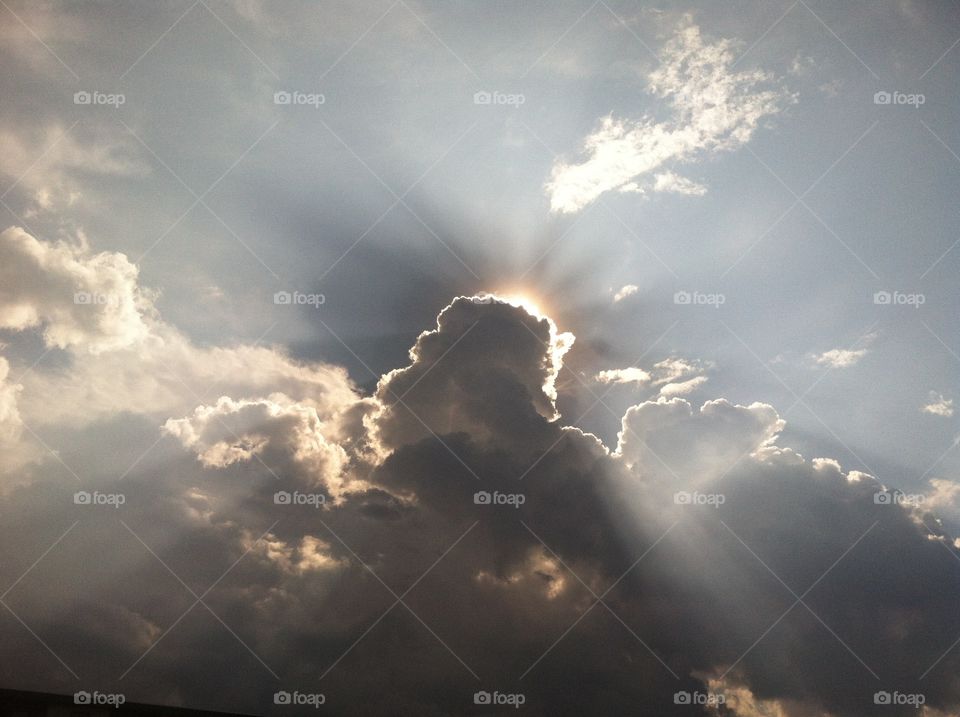Clouds. Bright rays of sunlight from behind the clouds