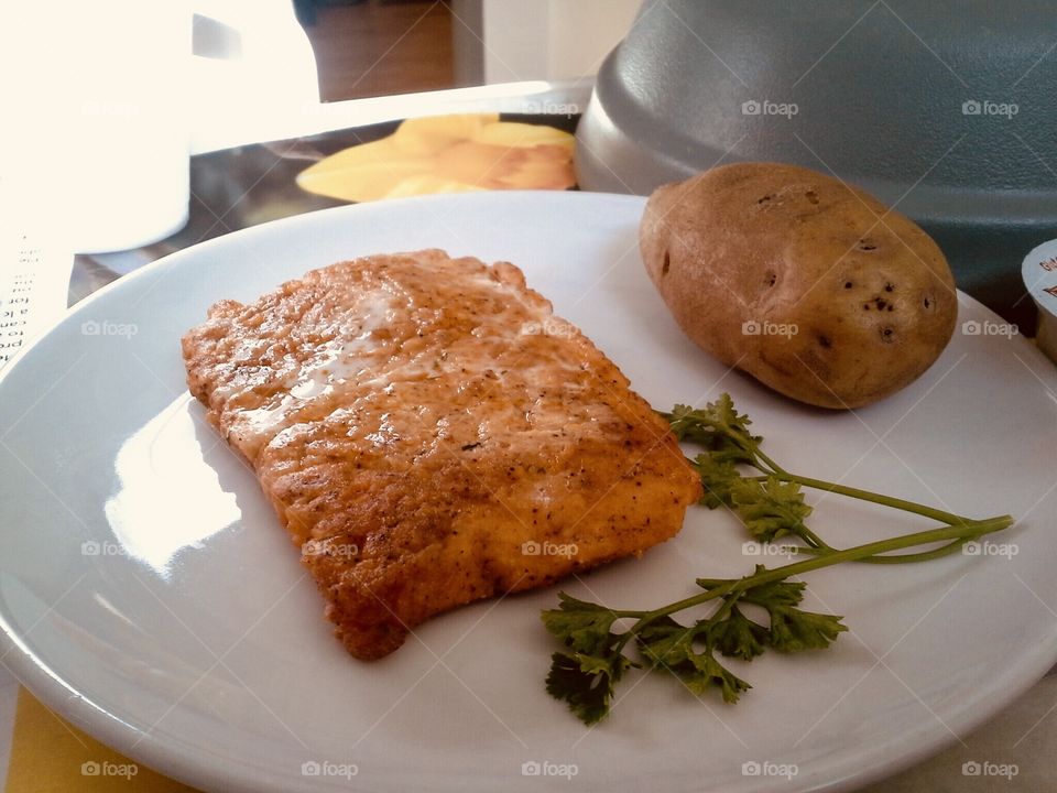 Salmon and baked potato from room service.