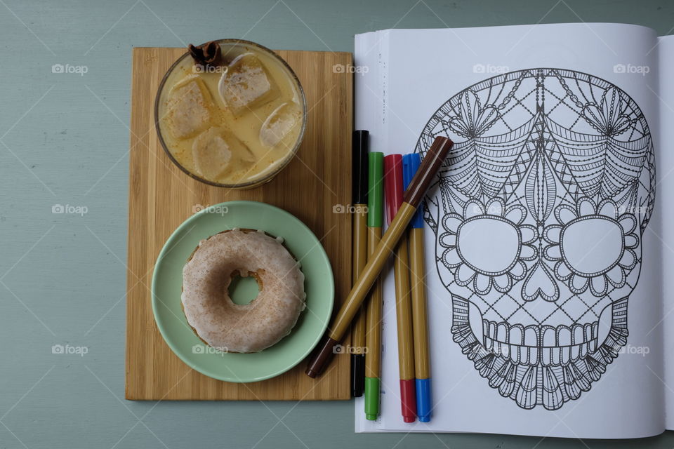 Doughnut and coffee with a sugar skull. 