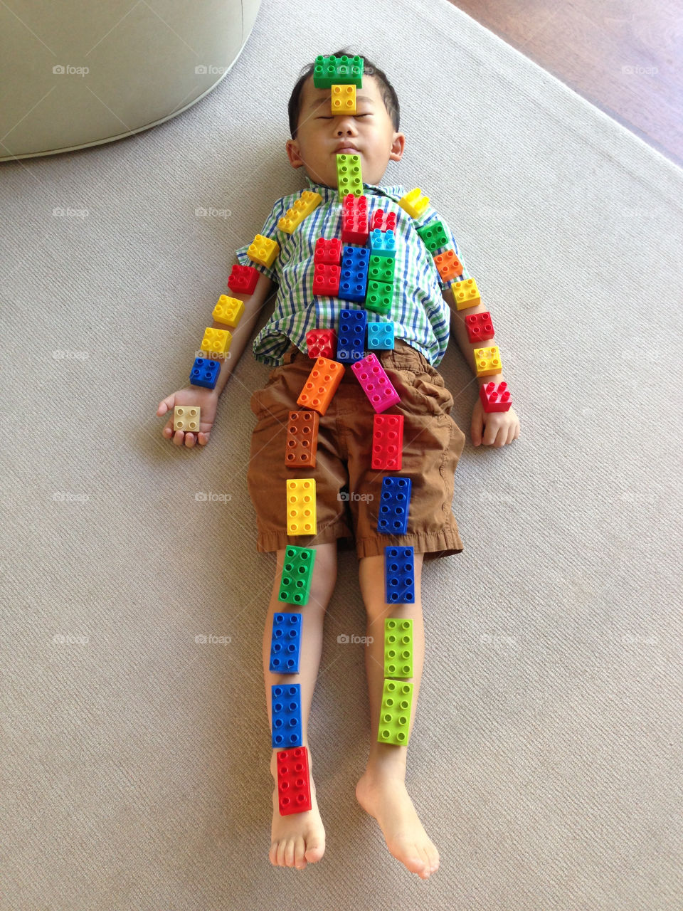 Asian boy with Lego skeleton. 