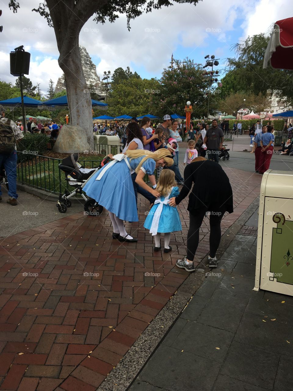Little girl with Alice In Wonderland at Disneyland.