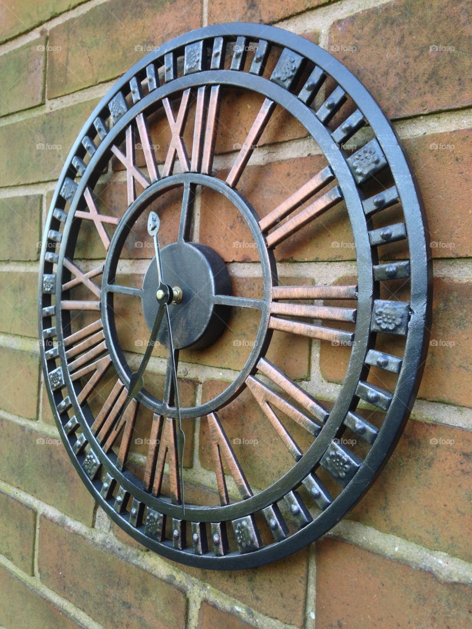 Rustic metallic clock.  Time on your hands.