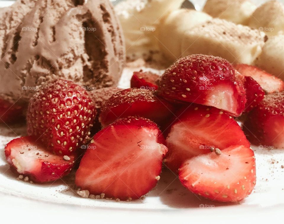 Strawberries, fresh from the garden served with chocolate ice cream and white chocolate ice cream bites
