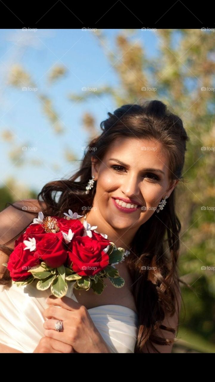 Bride with Bouquet of Red Roses 