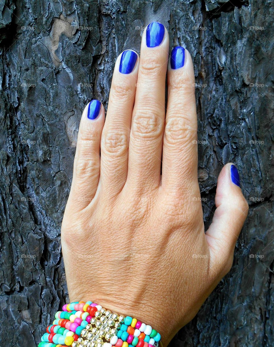 female hand manicure on a wooden background