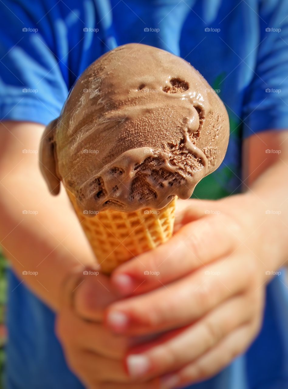 Hands Holding Ice Cream. Child Holding A Chocolate Ice Cream Cone
