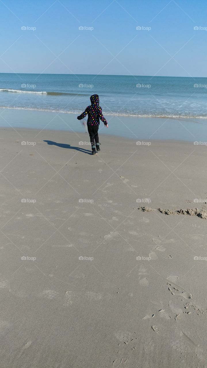 sand play run beach tides waves cold windy girl vacation travel fun