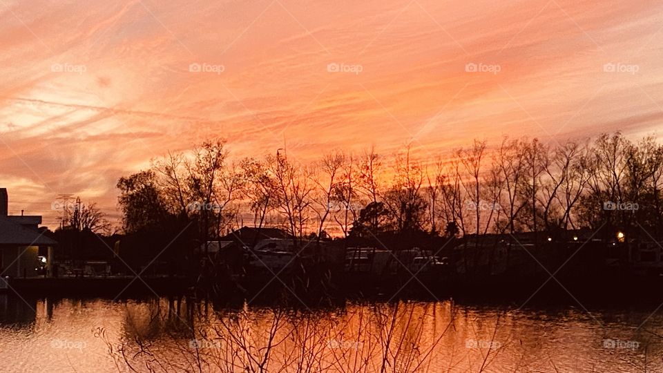High Clouds adjusting the sky during Sunset. Colors radiating within all the feathering of clouds with wind patterns. 