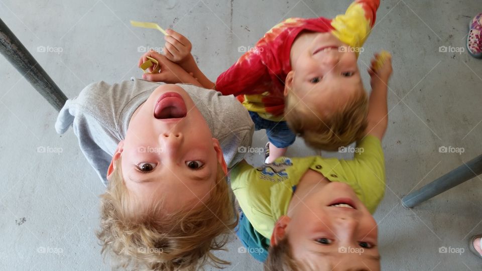 Upside Down View. Silly boys looking upward and backward while waiting in line.