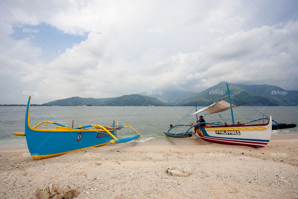 two boats by the beach