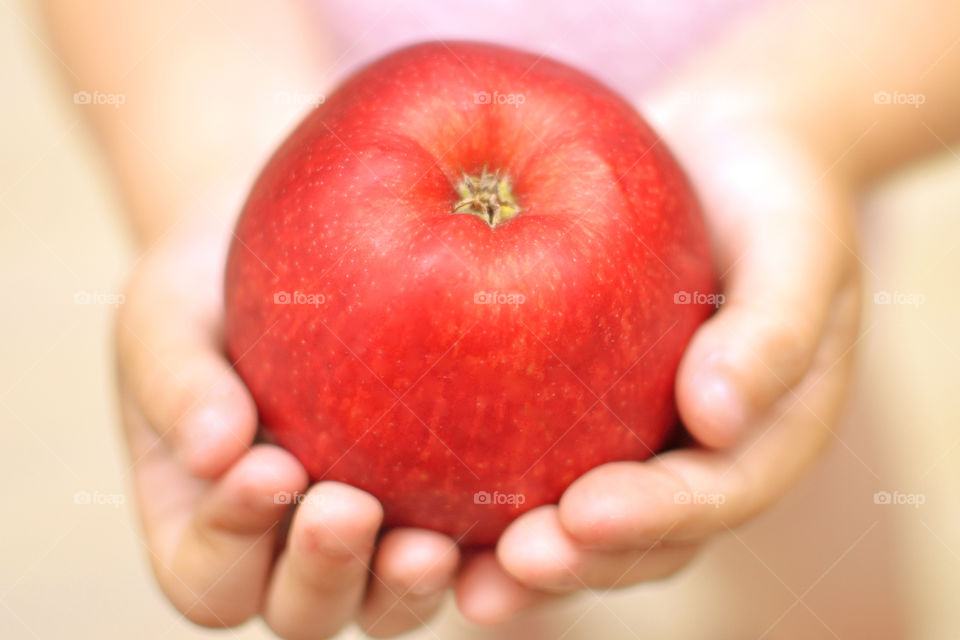 Red apple in child hands