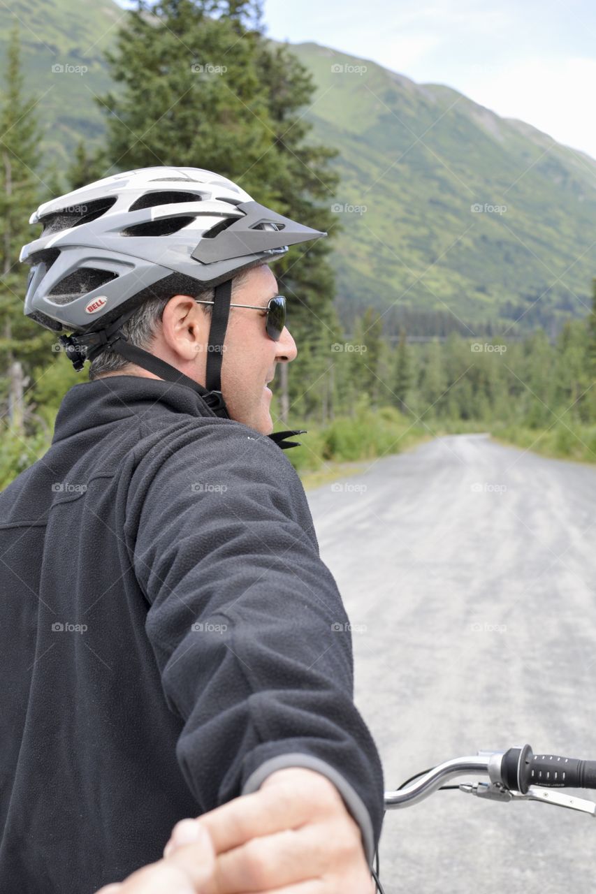 Young man with bicycle and helmet
