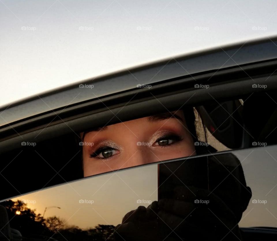 eyes looking through a car window