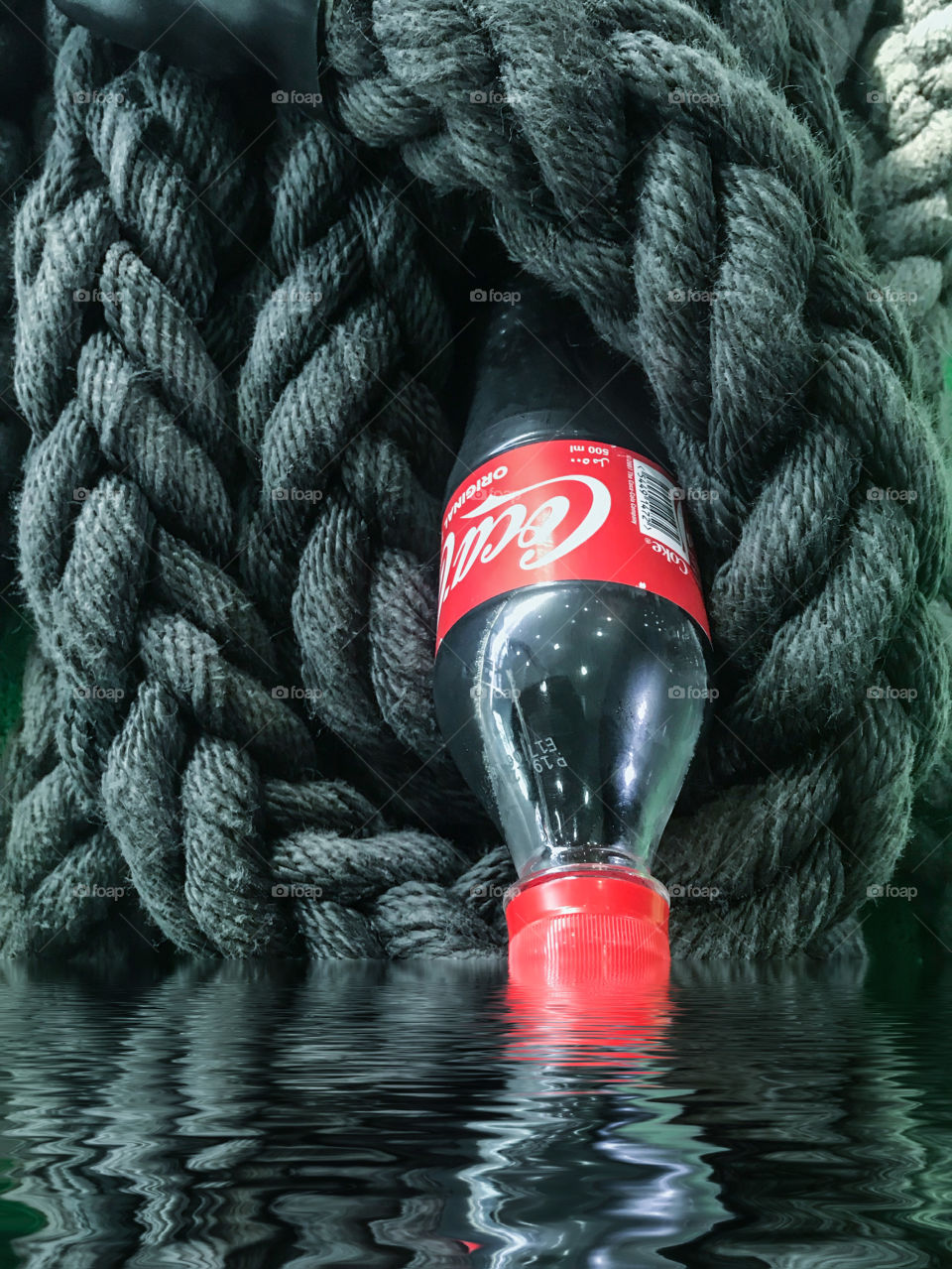 Coke touching the water reflection 