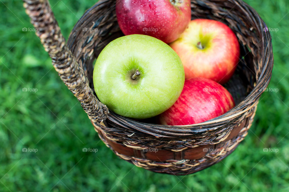 Red and green apple in basket