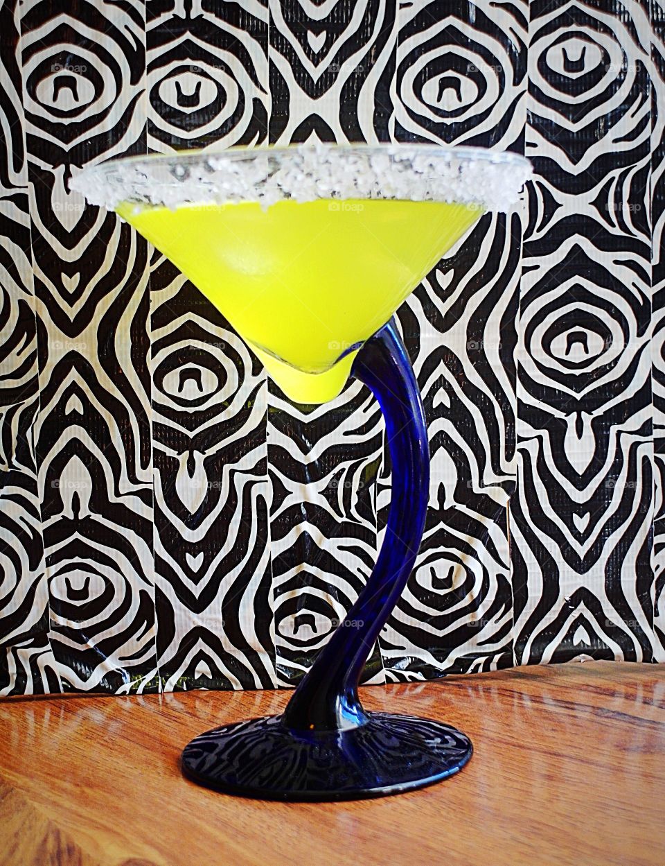 Yellow cocktail with zebra print background 
