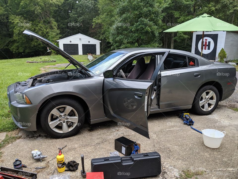 2011 Dodge Charger getting ready to be worked on in my driveway with parts and tools laying about