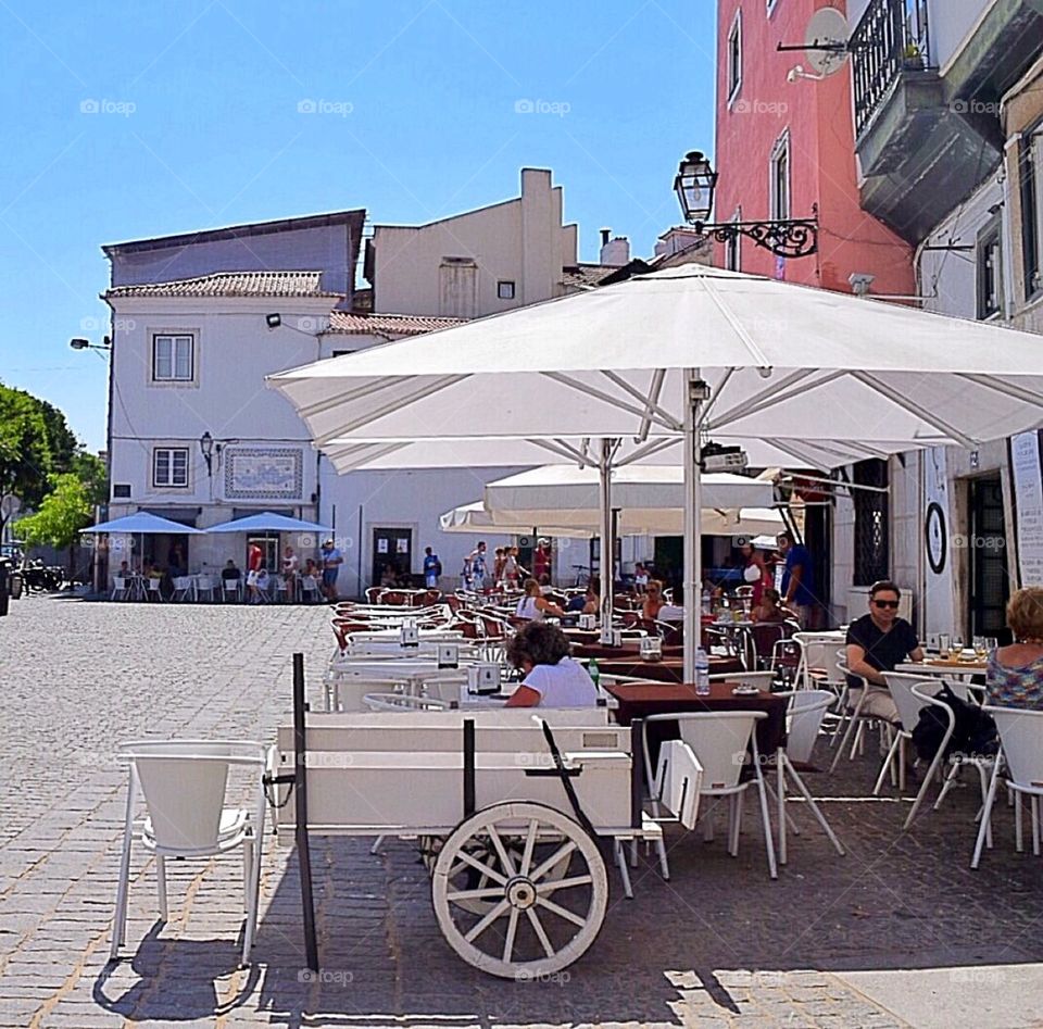 People relaxing and eating outside of the restaurant 