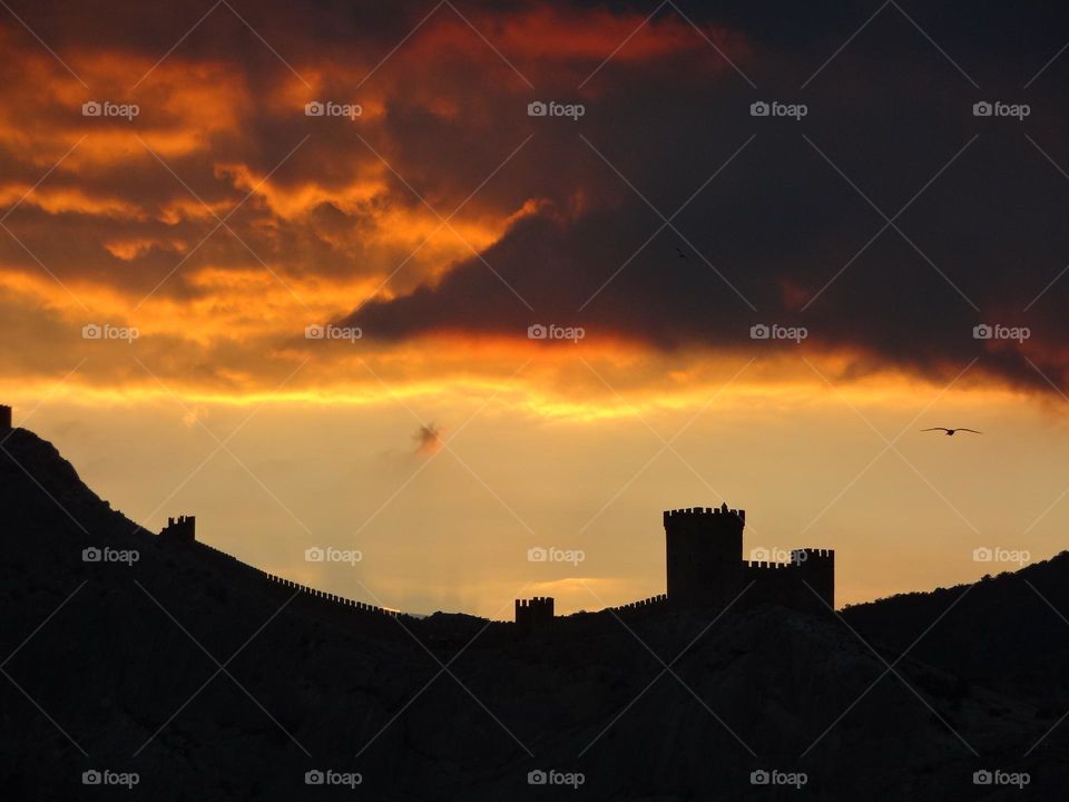 Old fortress against the sunset sky