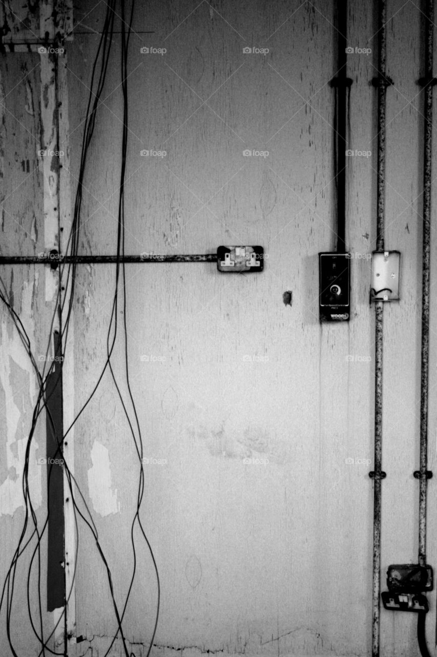 Disused wires and switches. Lots of wires, sockets and switches in an abandoned mill in Preston, Lancashire 