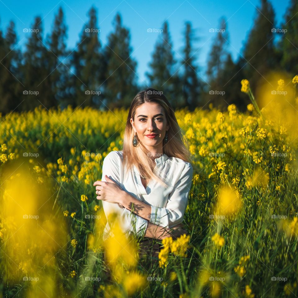 woman in field of flowers smiling