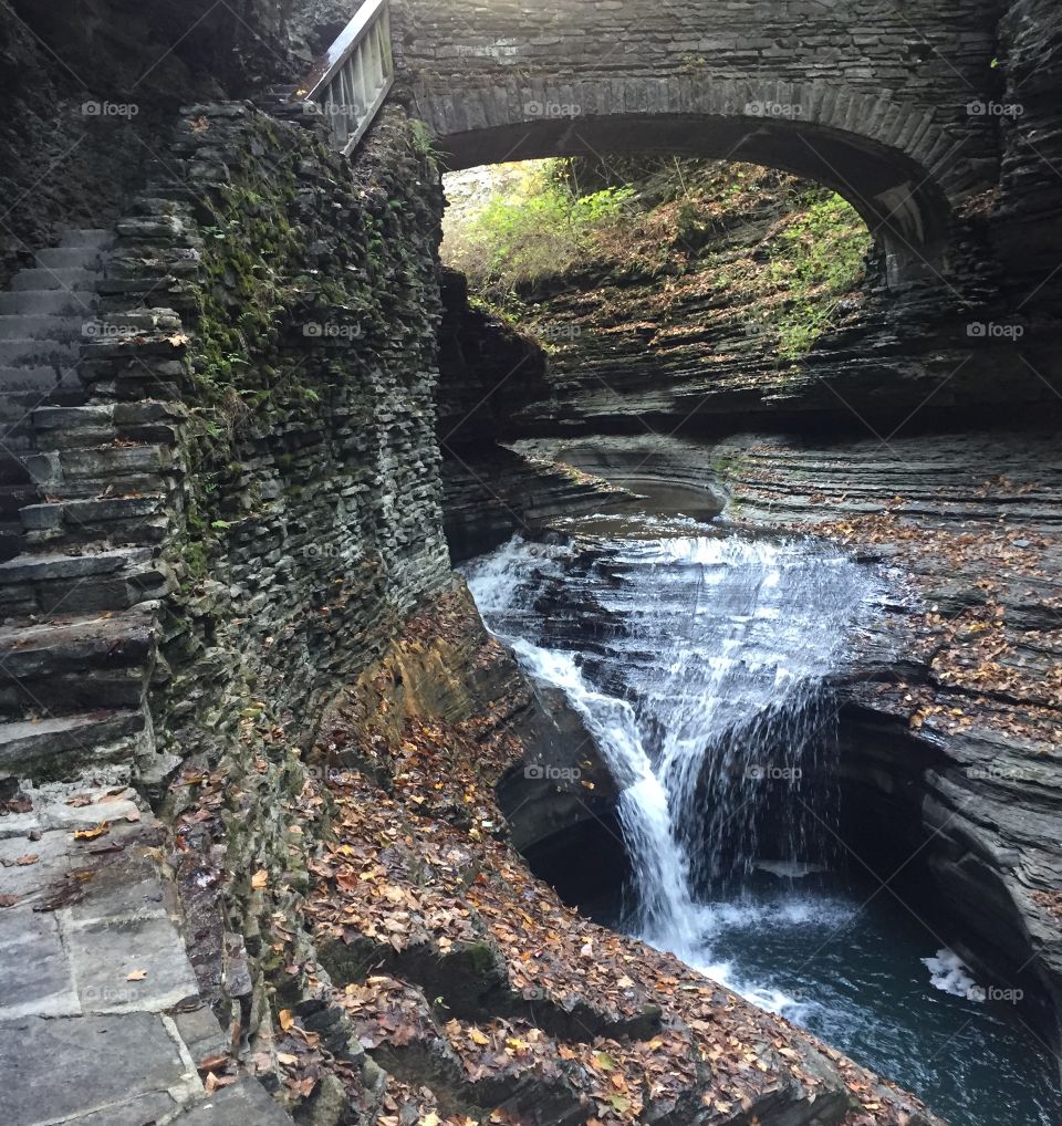 Beautiful falls between rocks and under a bridge 