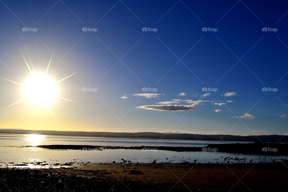 Winter Sun, Blue Sky and Clouds at Lindisfarne Island, Northumbria, England