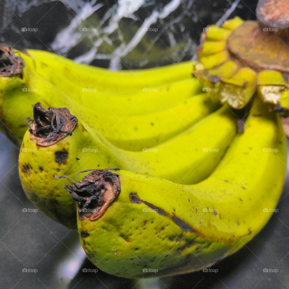 Green banana fruit on the table