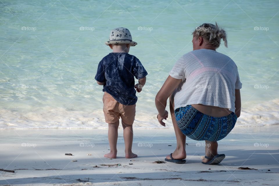 Mum and kid enjoy summer on the beautiful beach at Lipe island Thailand