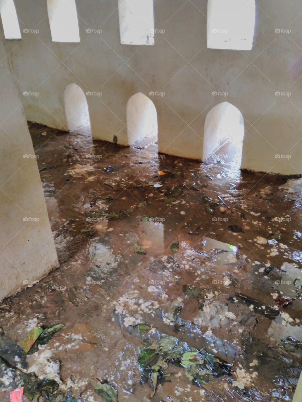 rain water running through manmade structure .