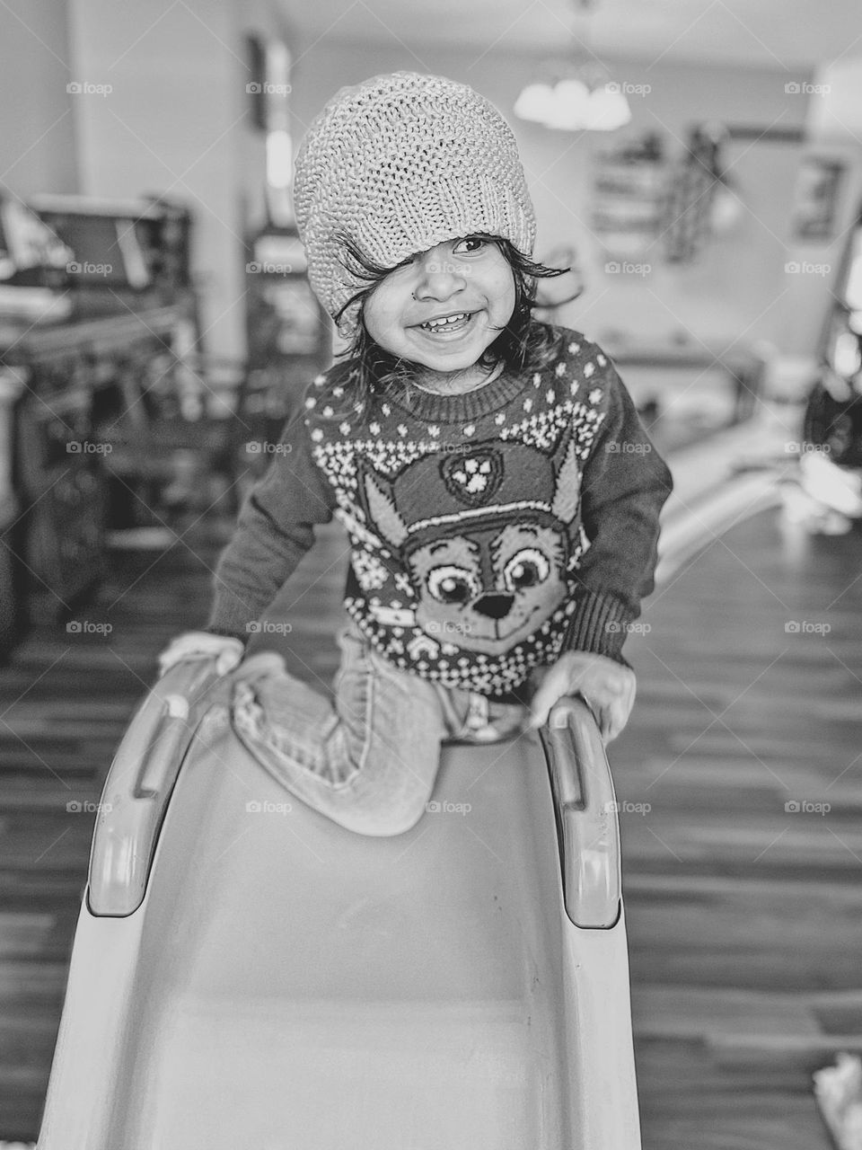 Toddler girl climbs up slide, toddler girl plays indoors, toddler girl portrait, natural beauty, natural portrait using a smartphone, mobile phone photography, portraits with a cell phone, black and white portrait, toddler girl smiling and having fun