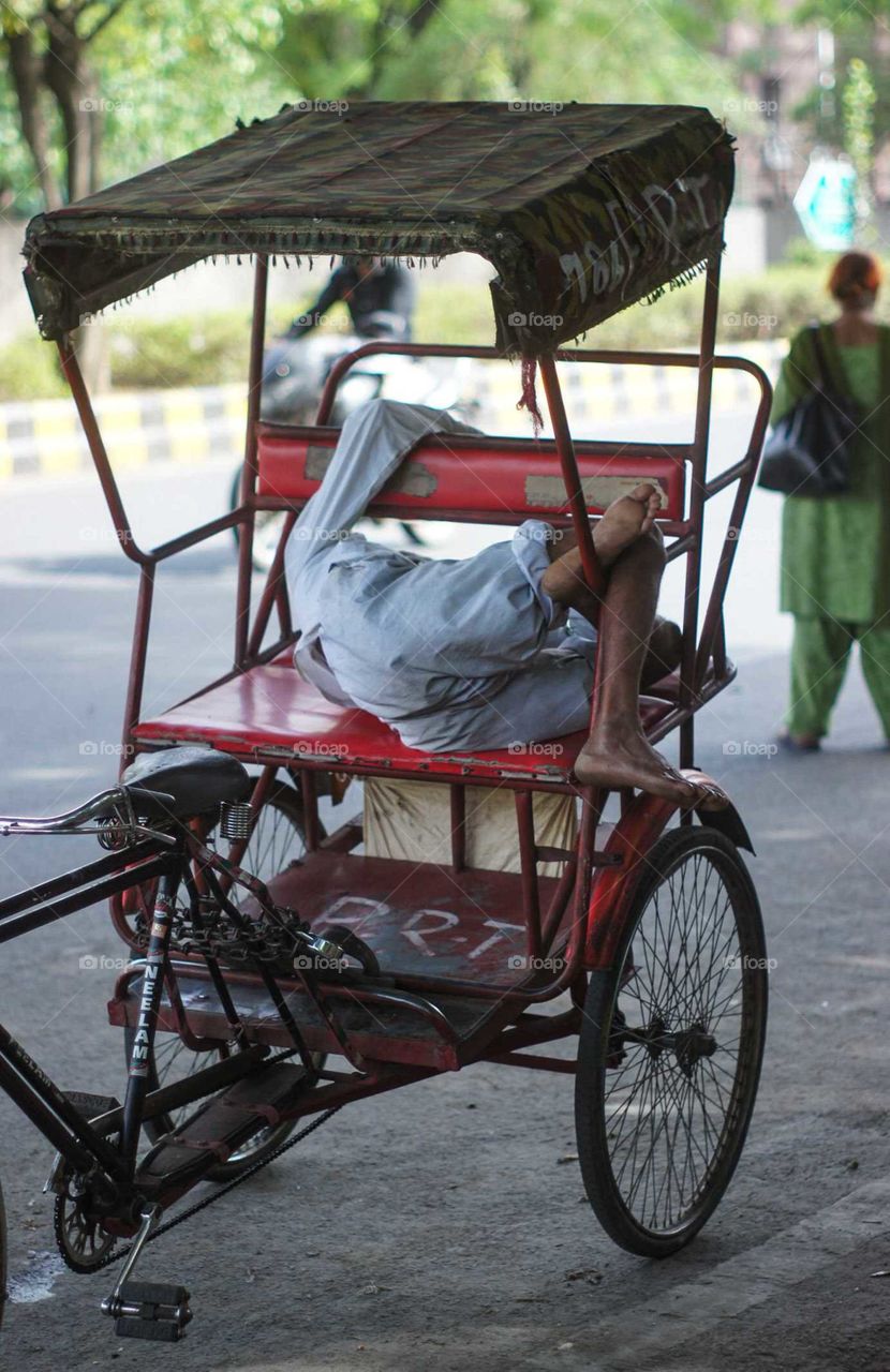 Tired rickshaw driver