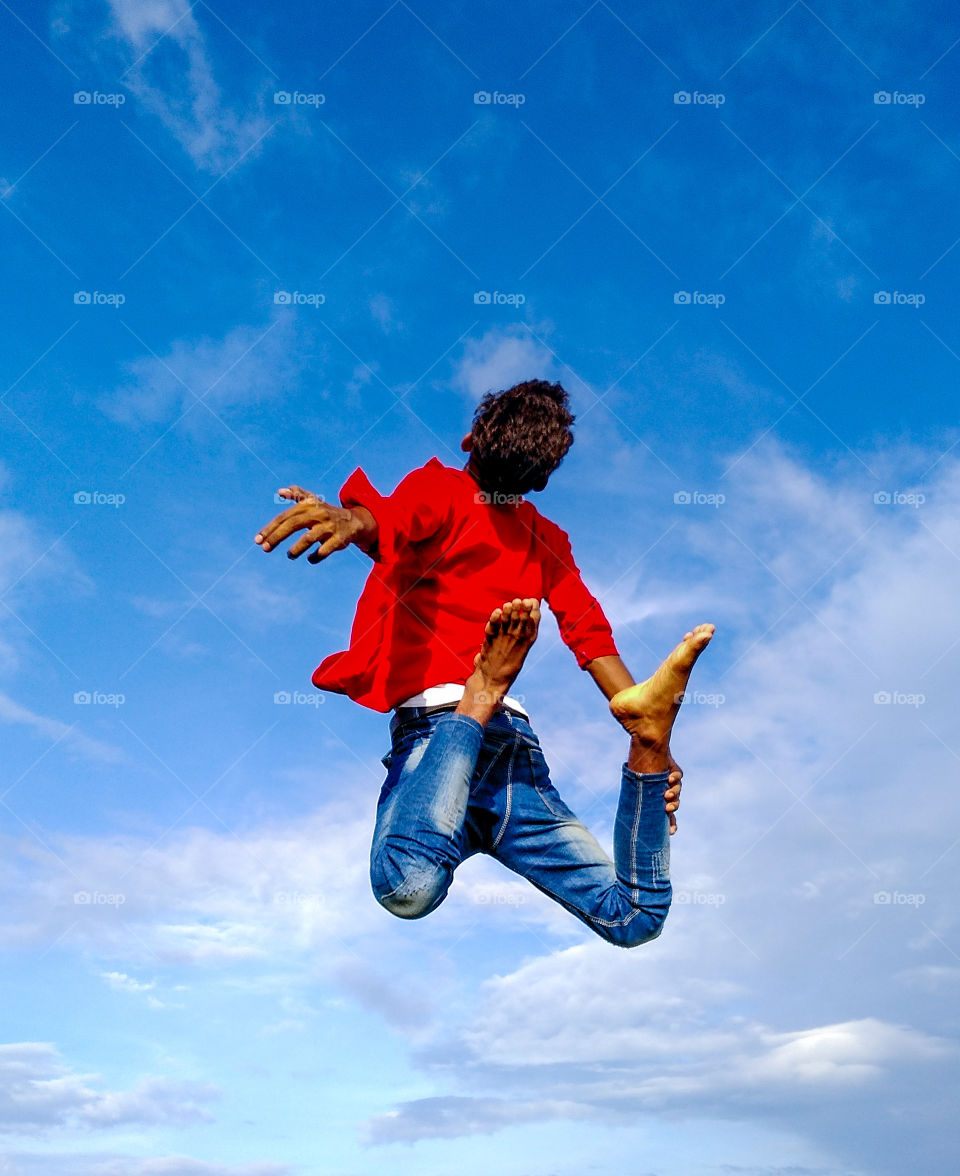 Get free from all difficulty. free your mind to fly in the sky like a bird. The peace of mind is the precious things than any other things in the world. The boy jumps like he wants to fly. Here the boy is represented as a mind.