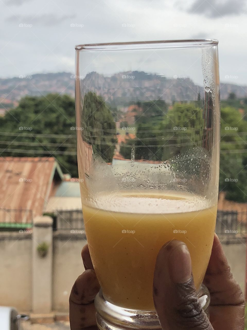 Kampala mountains in the glass . Yellow juice