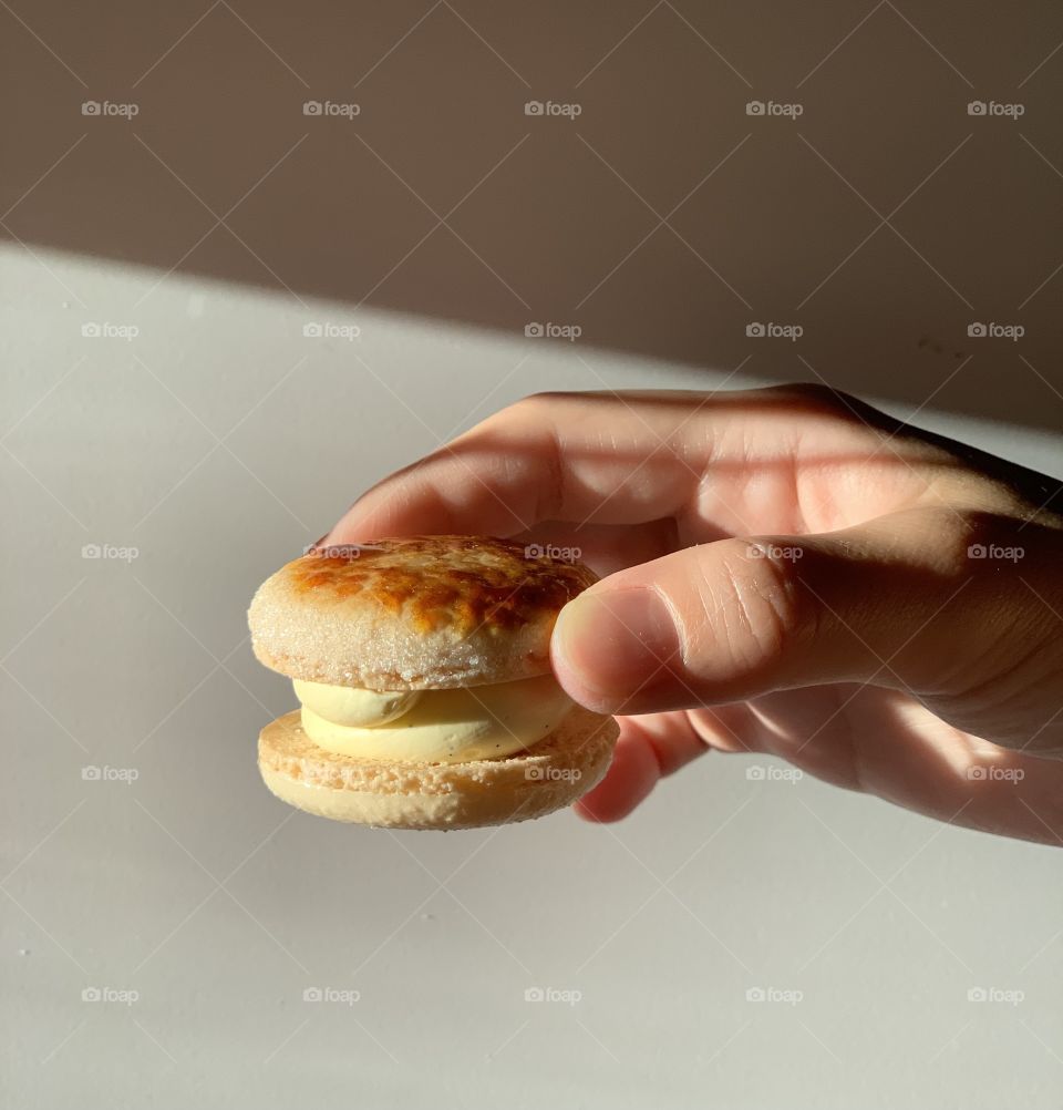 Holding onto creme brûlée fat macaron 