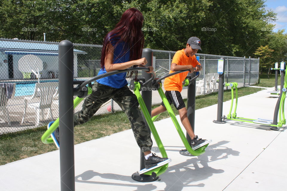 Two teens in an outdoor gym