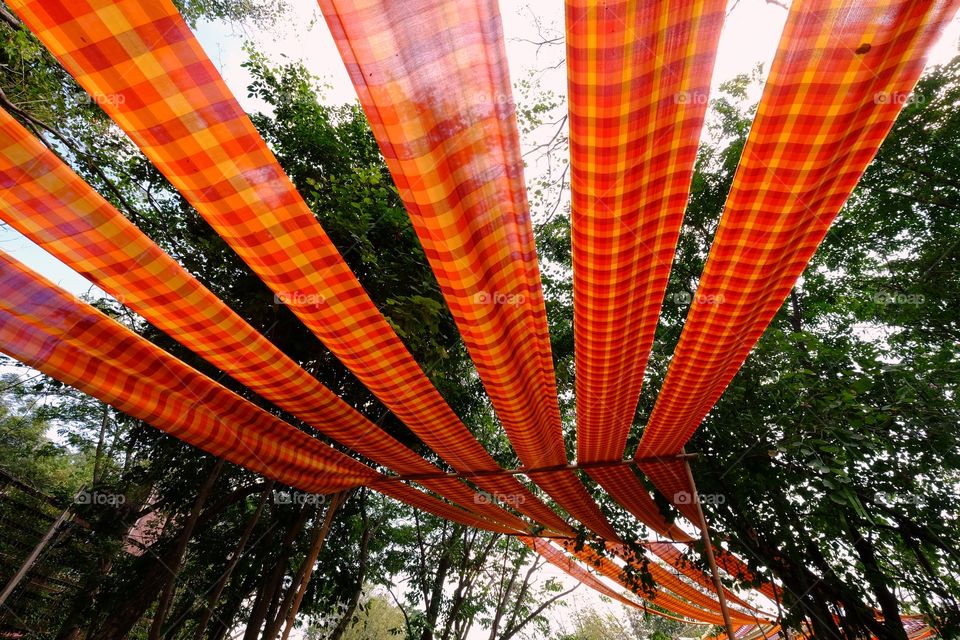 Orange woven fabric decorates the garden in vibrant colors