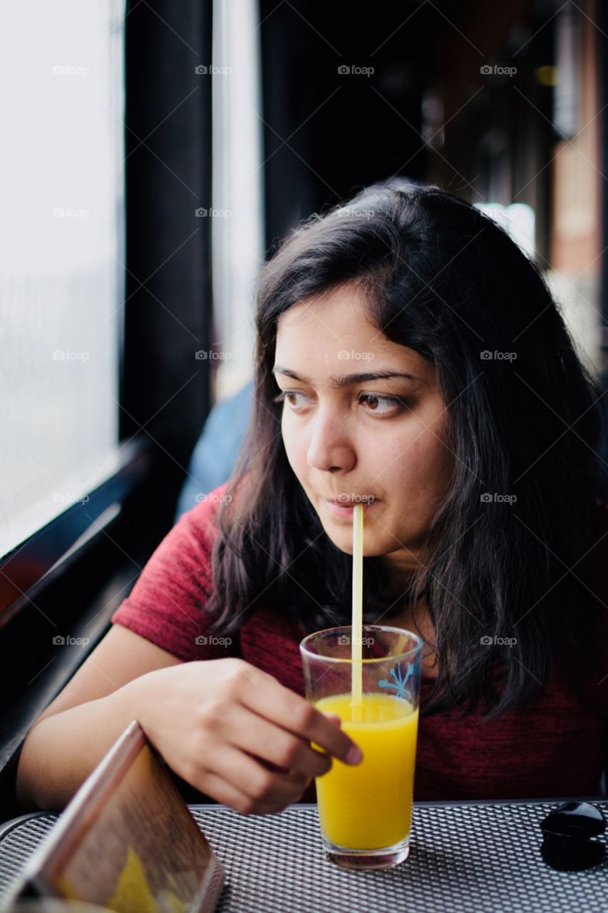 alone lonely  at restaurant drinking juice 