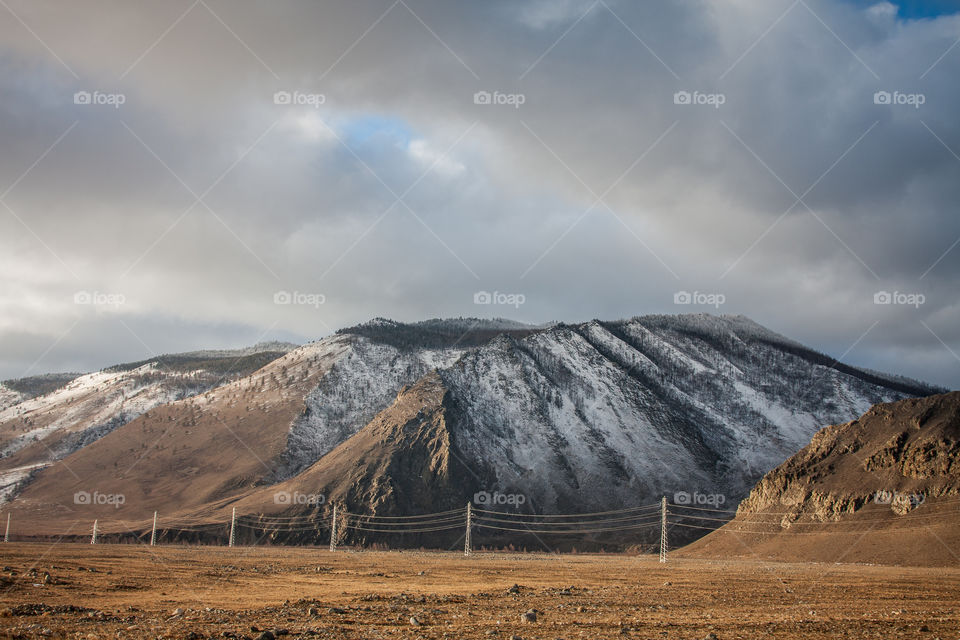 Distant view of electricity pylon and mountains