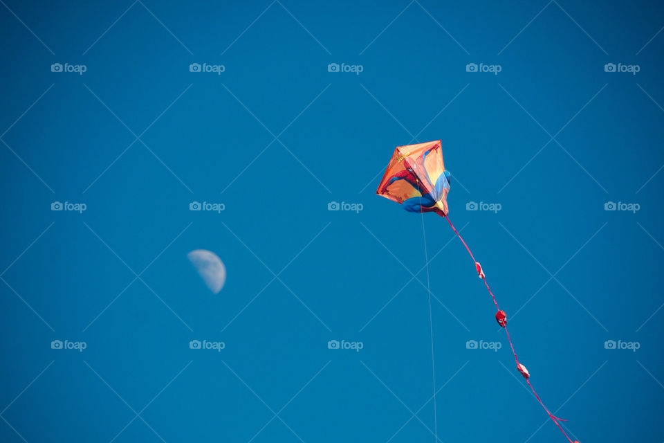 Flying a kite in the moonlight