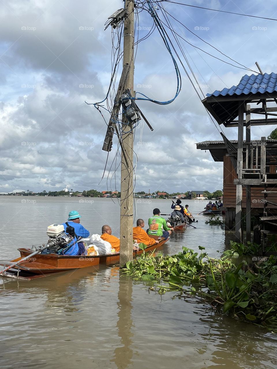 It's a ceremony of giving alms to monks by water, which happens only once a year.