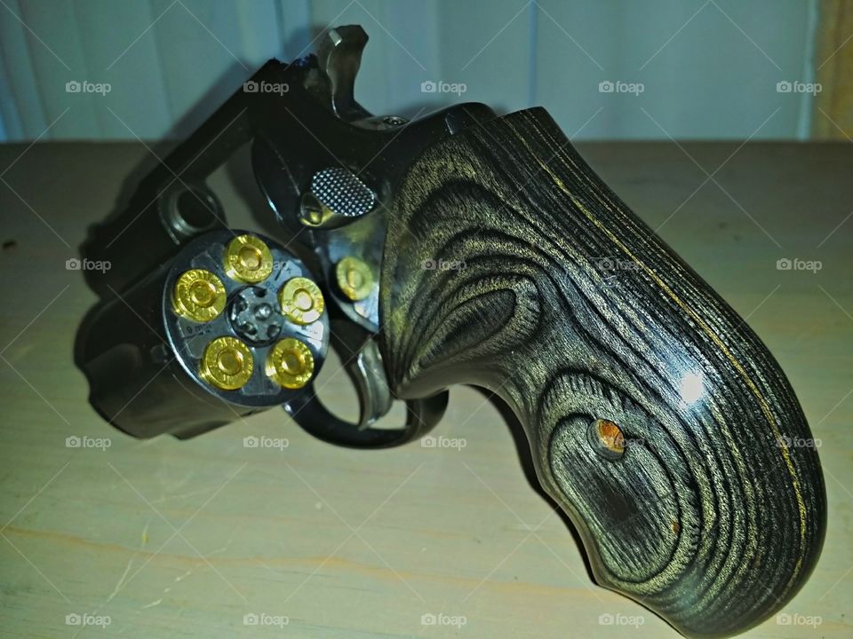Black Revolver w/Custom Grip. Revolver with open loaded cylinder, dark black blueing.