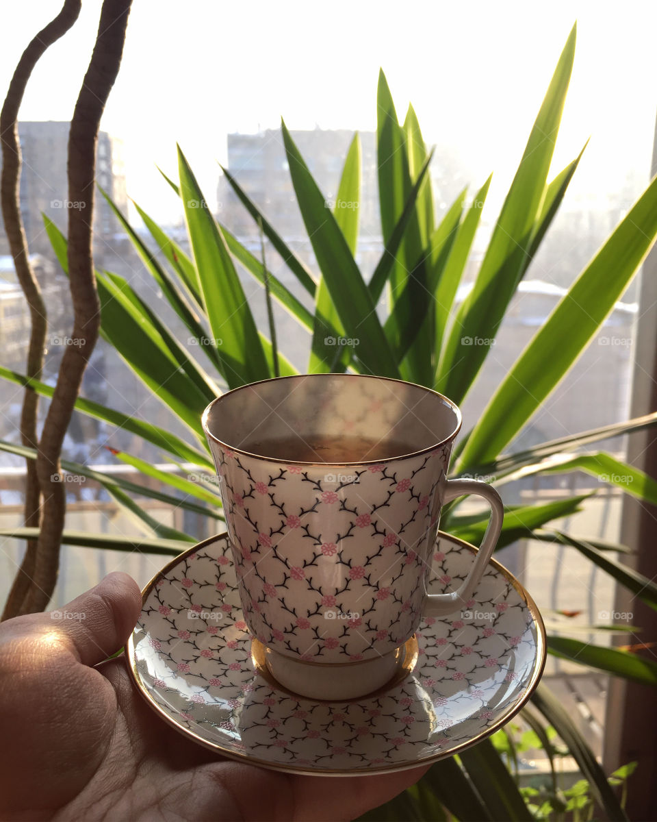 Drinking tea from the beautiful porcelain cup