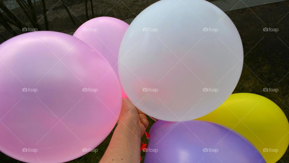 colour helium balloons in the hand flying