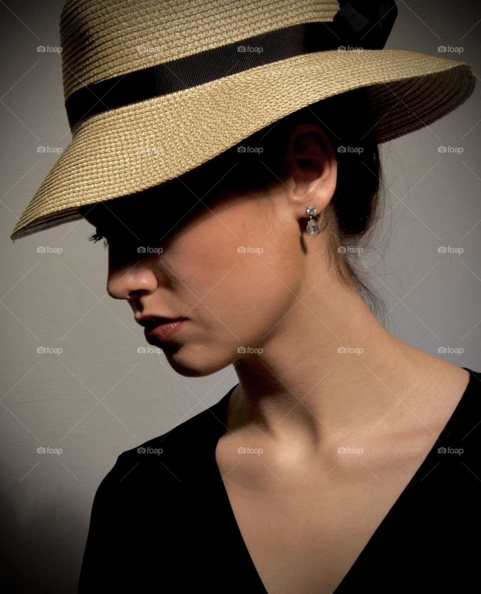 Sad looking woman with eyes shadowed by her hat