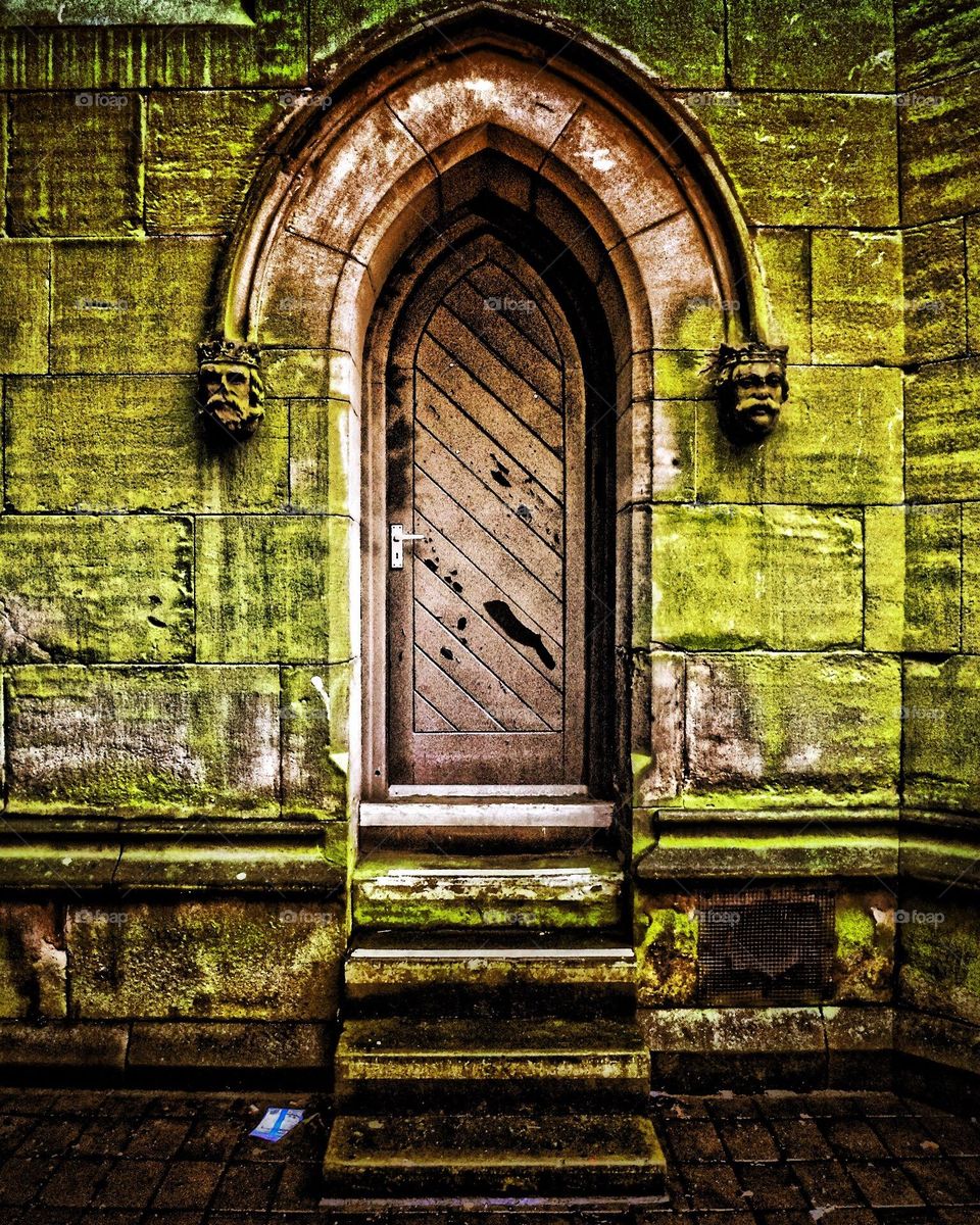 Spooky door on church, old door on building, scary objects on buildings, frightening building in England 