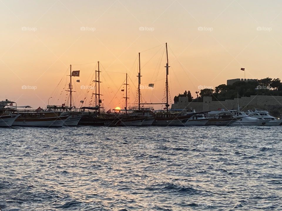 Beach time on holidays. Blue sky and tall palm trees. Sunsets and sunny days. Summertime in Kusadasi. Vacation travel in Turkey . Summer view. Sunny day during vacation 
