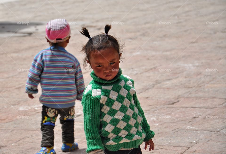 kids in the buddhist monastery yard in tibet