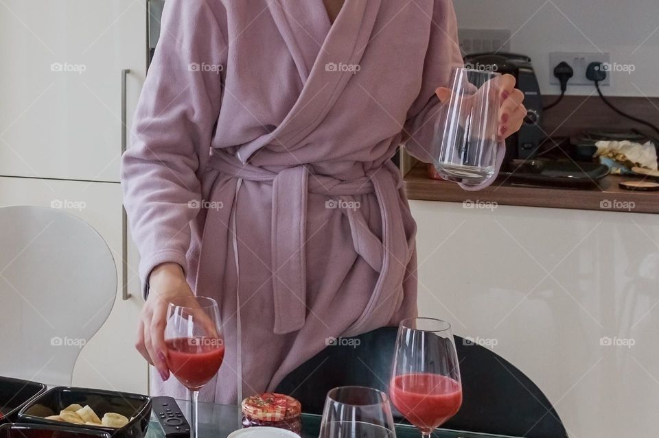 Hands holding glasses with juice 